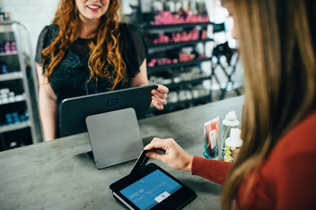 Woman paying at till